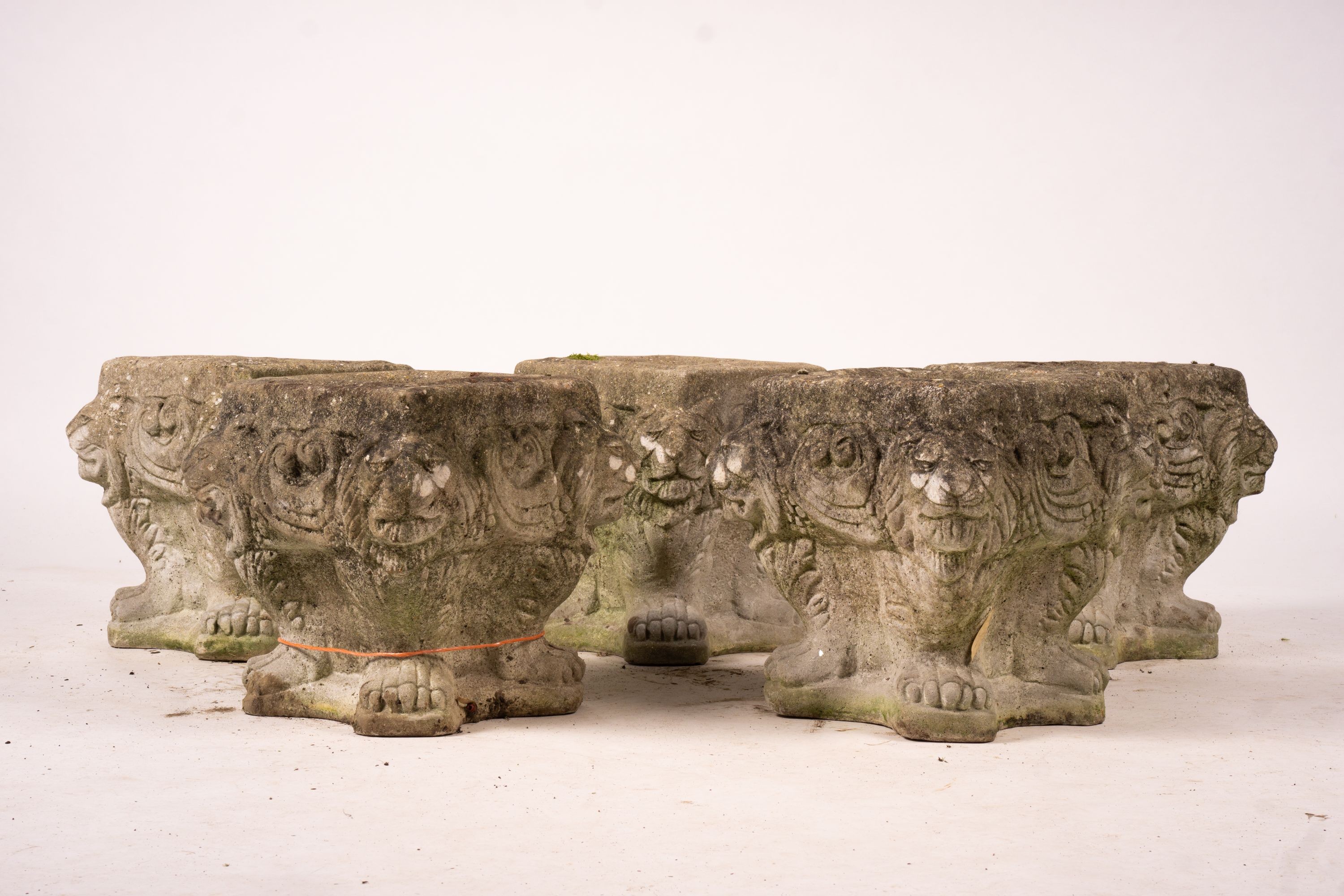 A set of five reconstituted stone lion mask square garden planters, W.30cm H.32cm